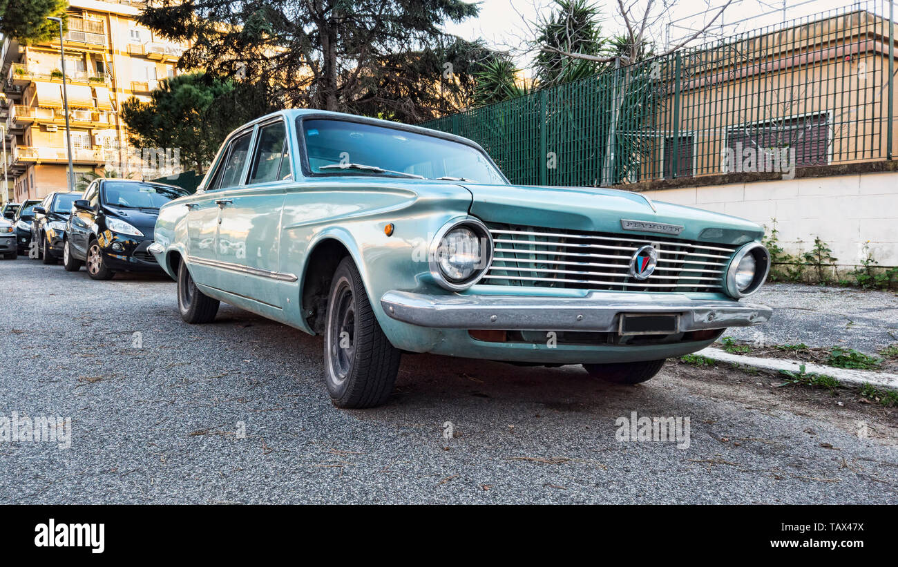 Ostia Lido Rome, Italy - February 4, 2019 : Parked in the street a classic vintage grey car model Valiant produced by American automotive industry Ply Stock Photo