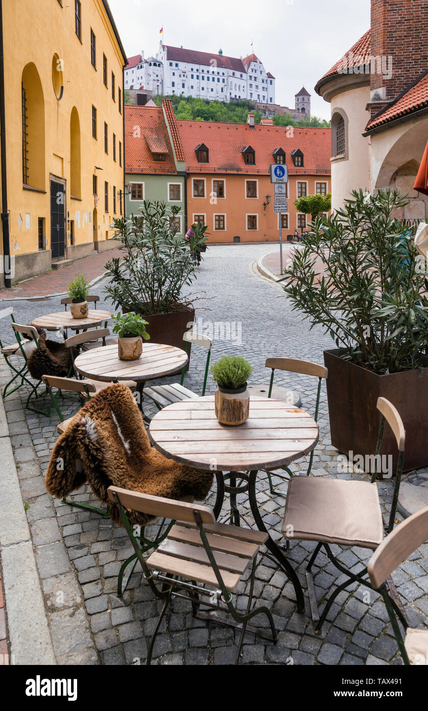 Landshut Old town with street cafe tables and Trausnitz medieval castle seen in background, Bavaria, Germany, Europe Stock Photo