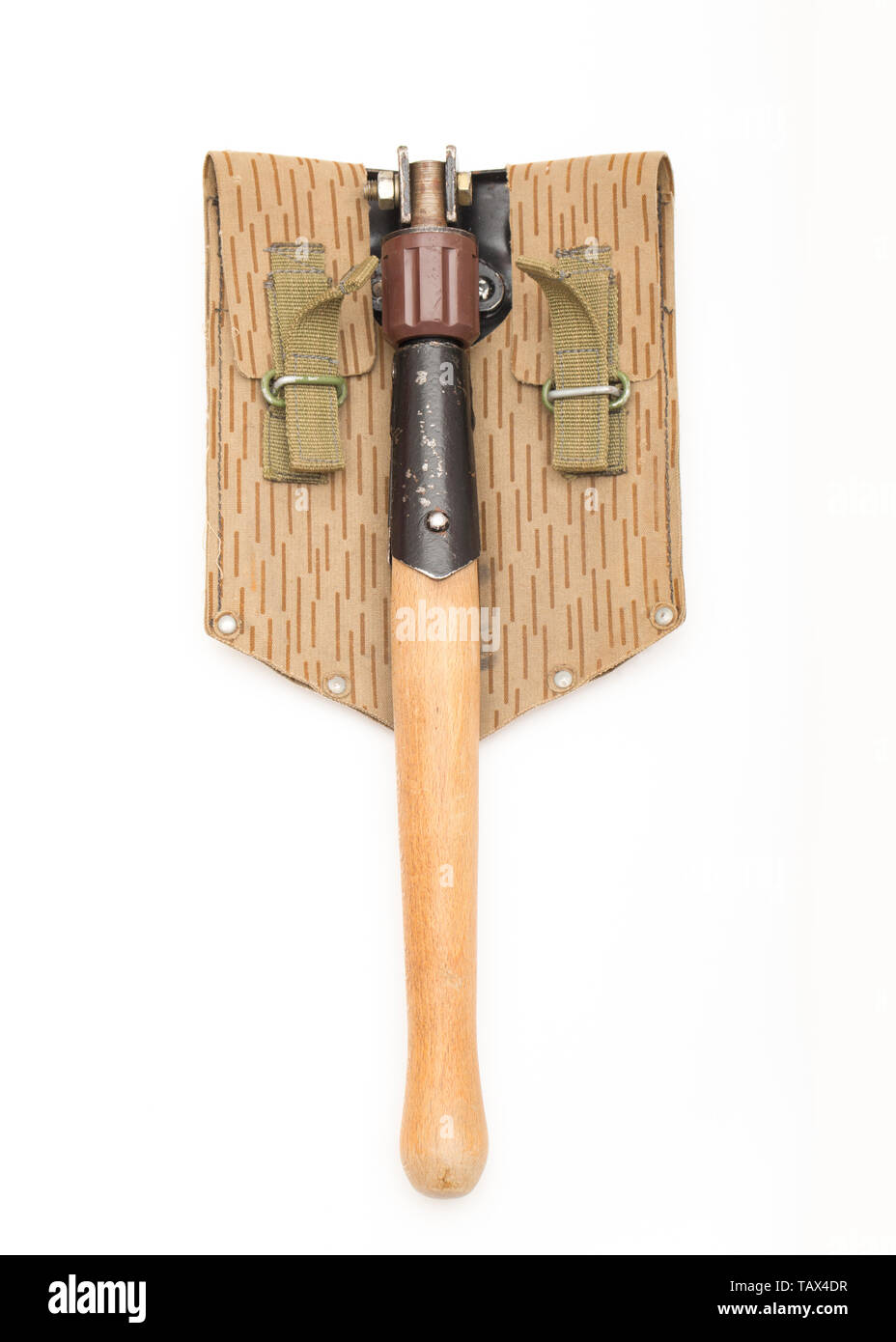 A military folding shovel made in the German Democratic Republic bought from an army surplus store in the UK. It has a wooden handle and a sawtooth ed Stock Photo