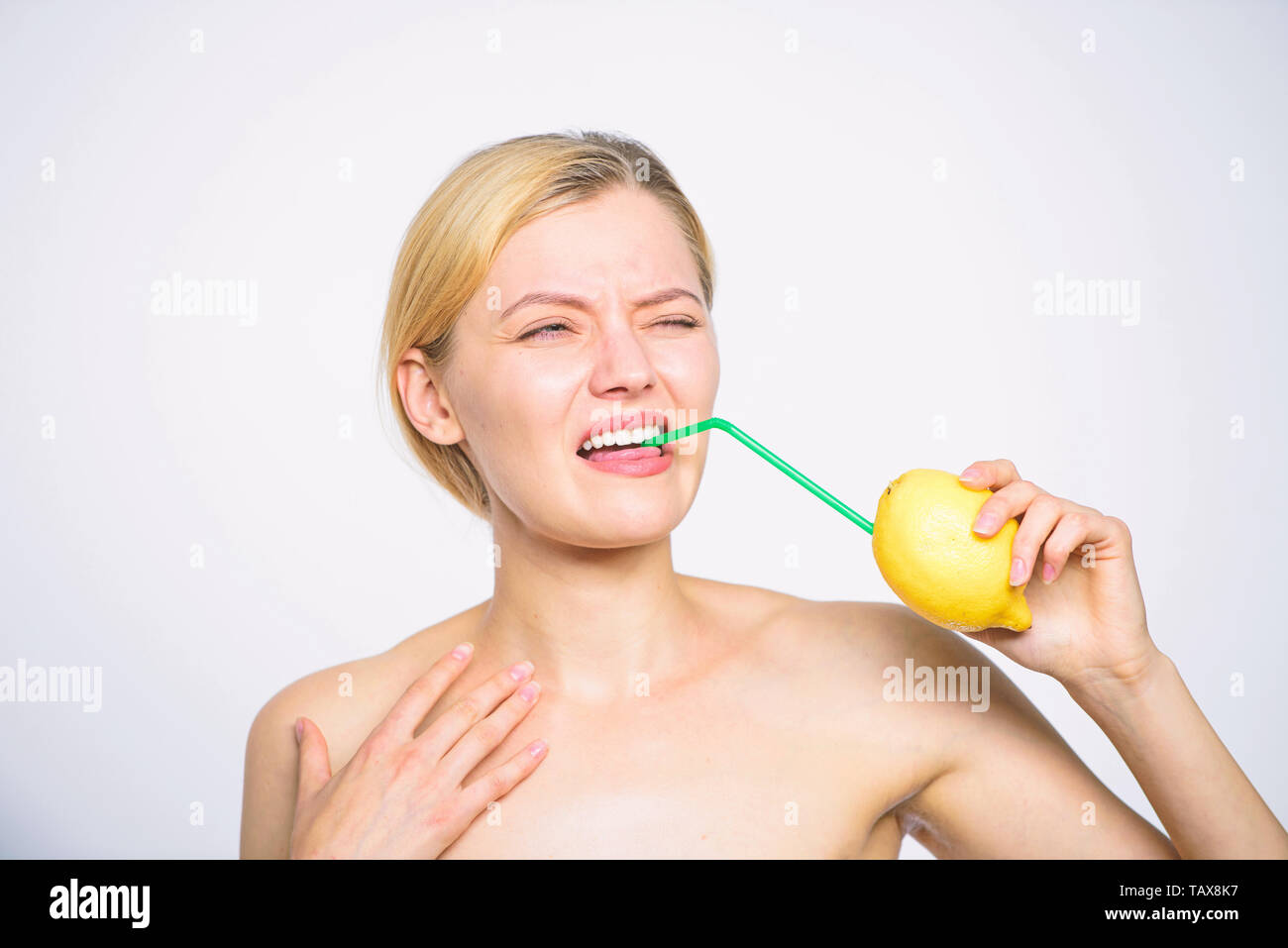 Girl drink fresh juice whole lemon fruit cocktail straw. Sour taste