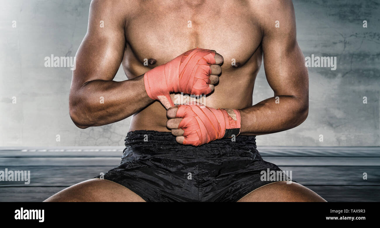 Close up of hand boxer pulls wrist wraps before training. Stock Photo