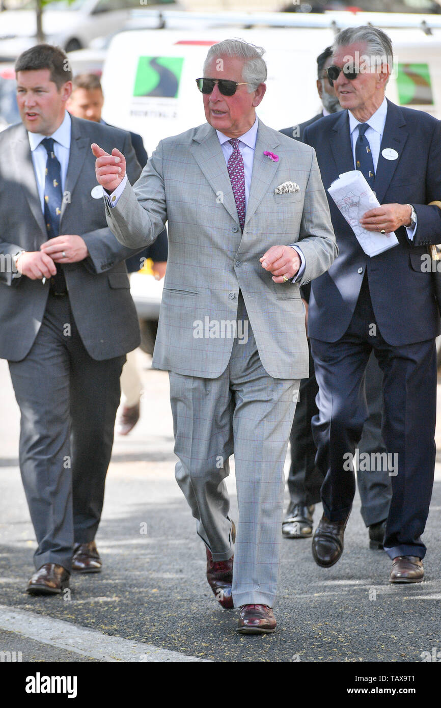 The Prince of Wales (centre) walks to the Duchy of Cornwall office in Poundbury in Dorchester, Dorset, to view an exhibition, including one of his own watercolours, as part of the Open for Art project. Stock Photo