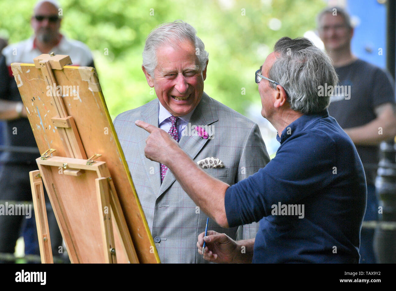 The Prince of Wales talks with an artisit during his visit to the Duchy of Cornwall office in Poundbury in Dorchester, Dorset, to view an exhibition, including one of his own watercolours, as part of the Open for Art project. Stock Photo