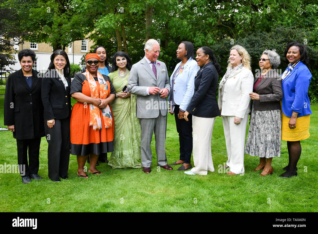 The Prince of Wales (centre) stands with Commonwealth representatives during his visit to the Duchy of Cornwall office in Poundbury in Dorchester, Dorset, to view an exhibition, including one of his own watercolours, as part of the Open for Art project. Stock Photo
