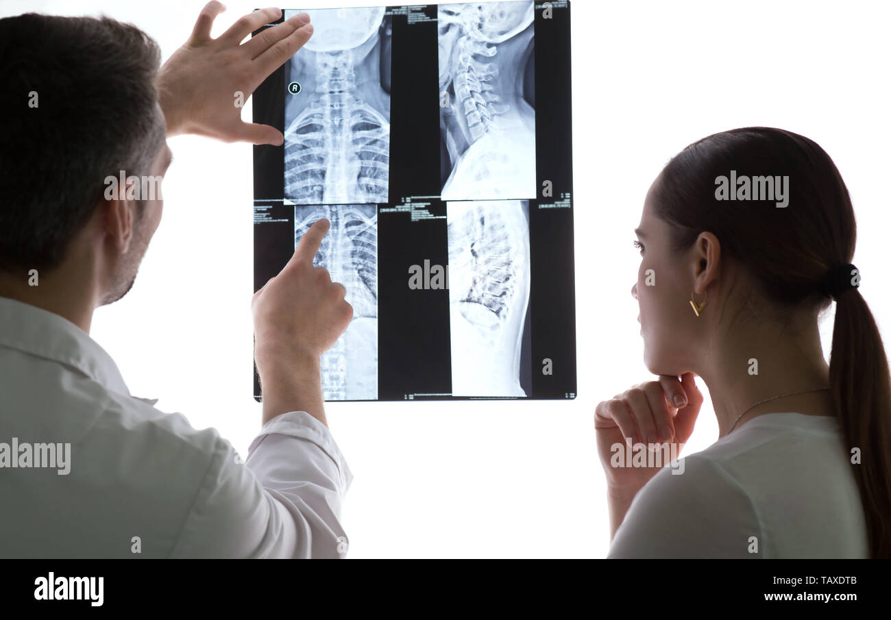 Two doctors discussing patients xray and MRI scans, Spine xrays Stock Photo Alamy