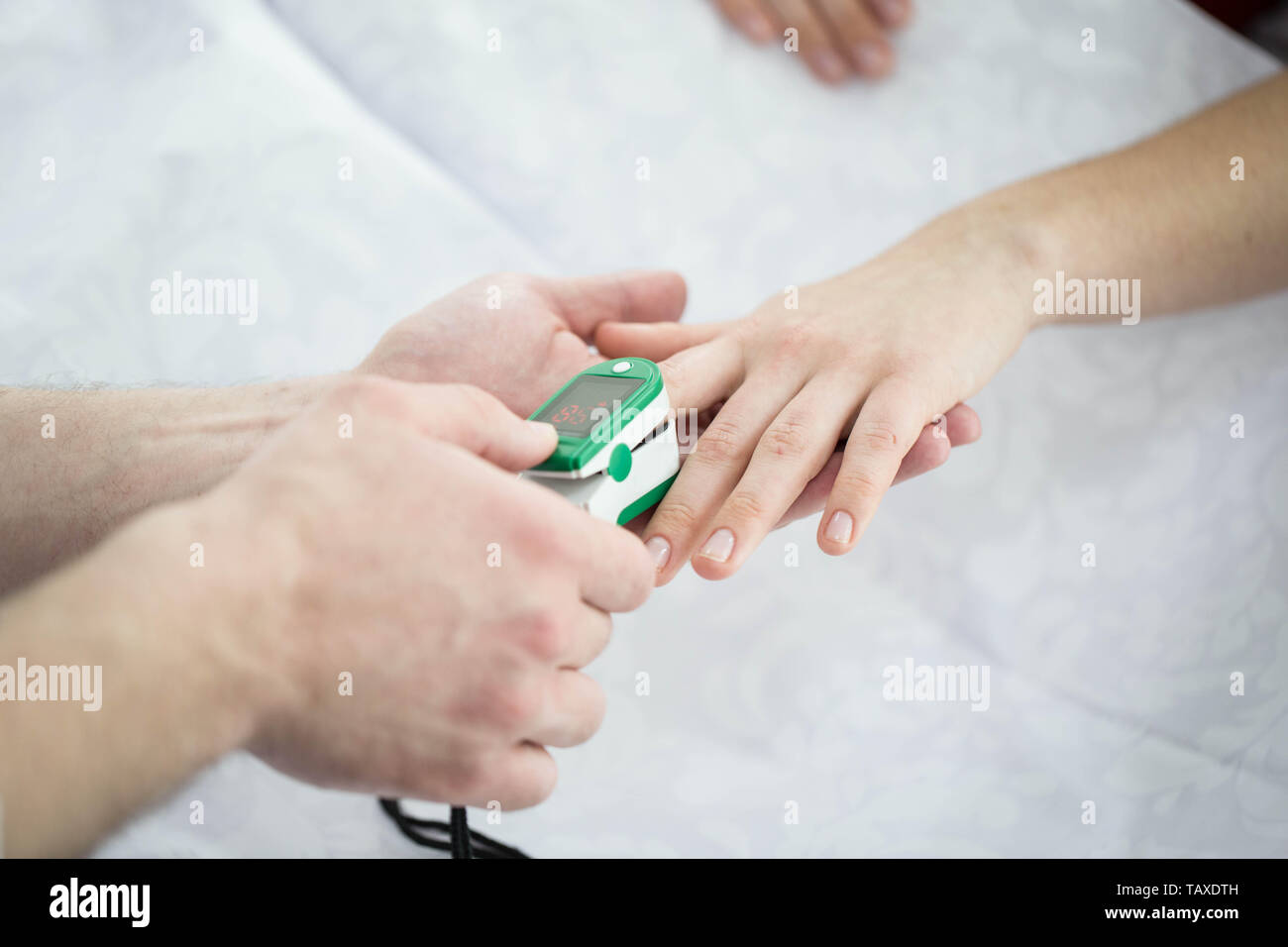 Patient Finger Pulse Trace Oximeter close-up. Taking Pulse Stock Photo