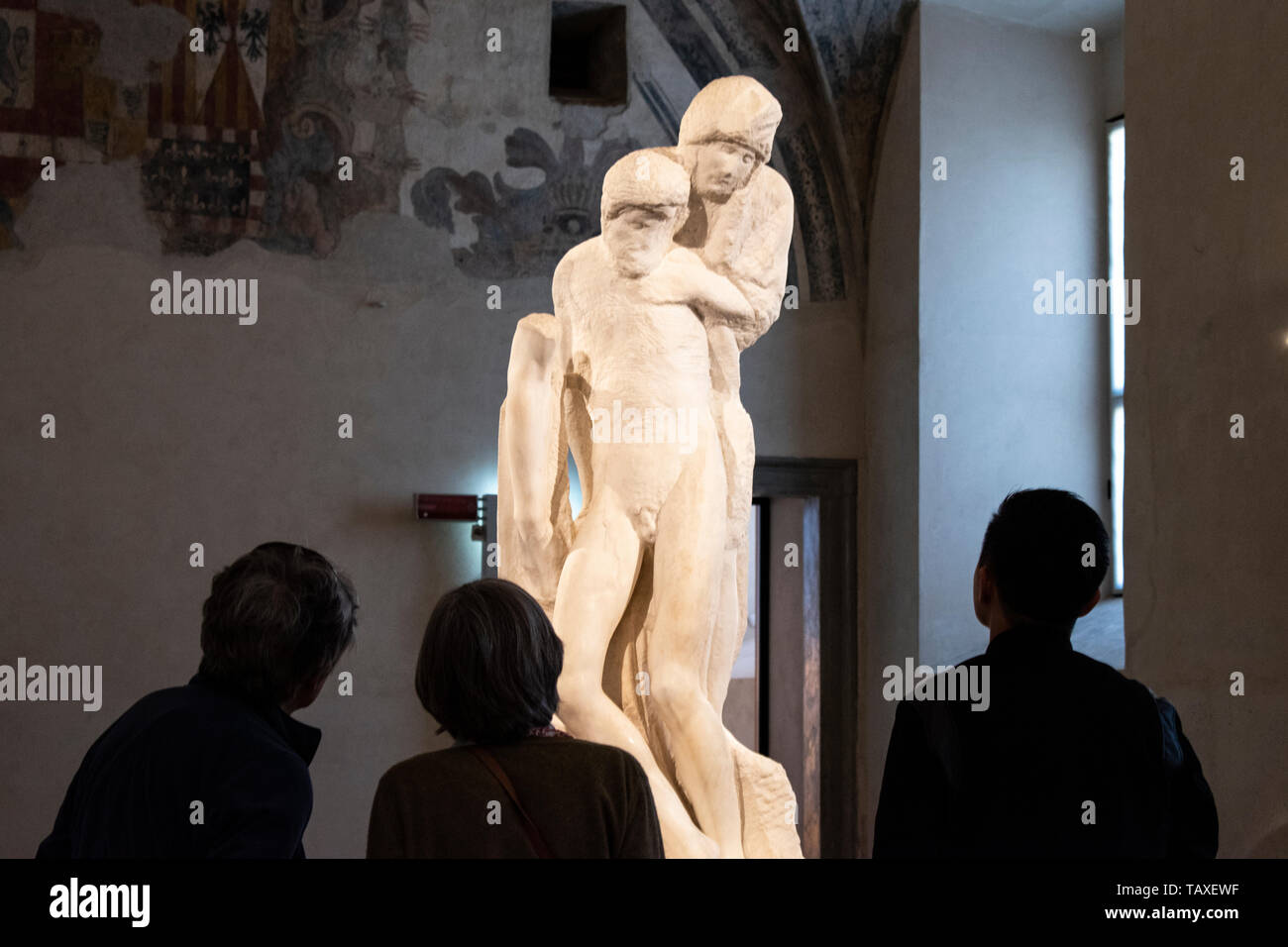 Sforza Castle, museum, Milan: people in front of The Rondanini Pietà, sculpture that Michelangelo worked on from 1552 until his death in 1564 Stock Photo