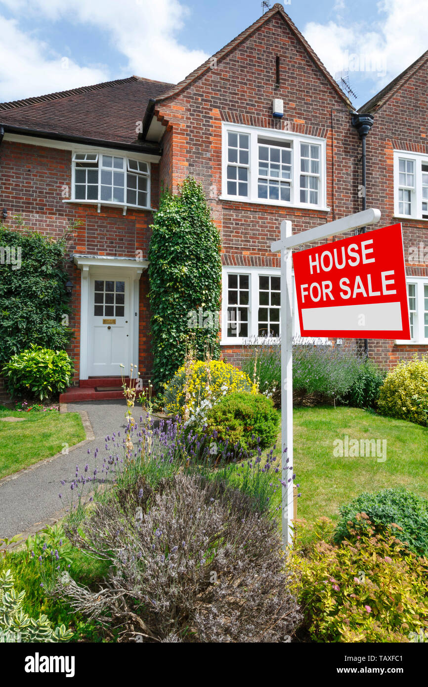 House for sale sign outside a typical UK semi-detached house in London Stock Photo