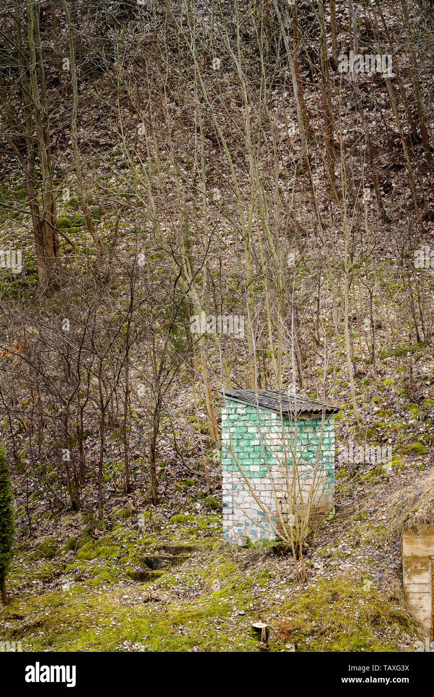 Old rural toilet made of bricks by the forest Stock Photo