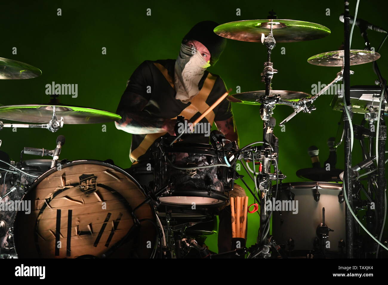 Drummer Josh Dun is shown performing on stage during a "live" stand up