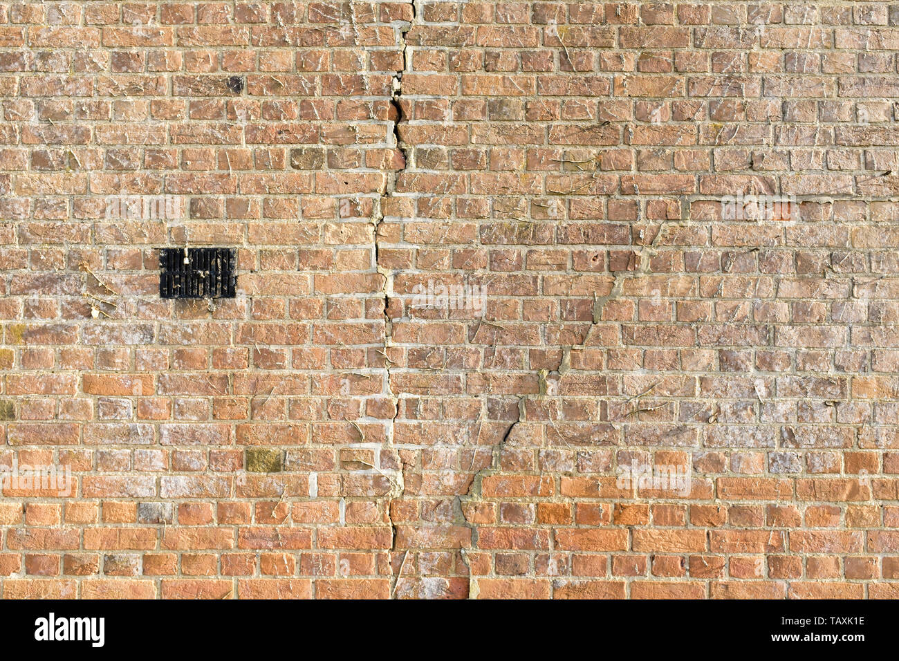 Large cracks in a brick wall due to subsidence Stock Photo