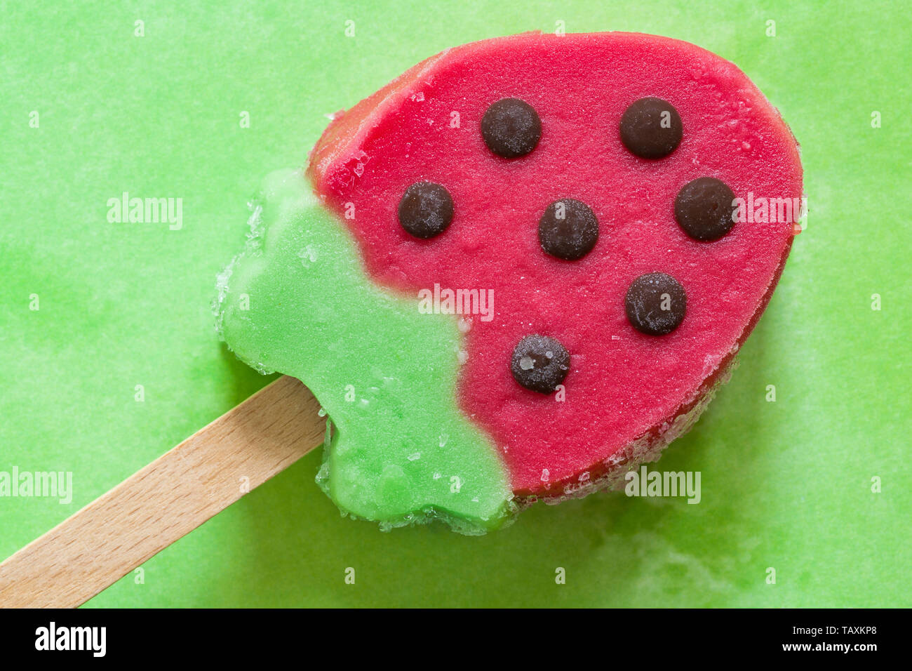 Rowntrees Strawberry ice lolly set on green patterned background