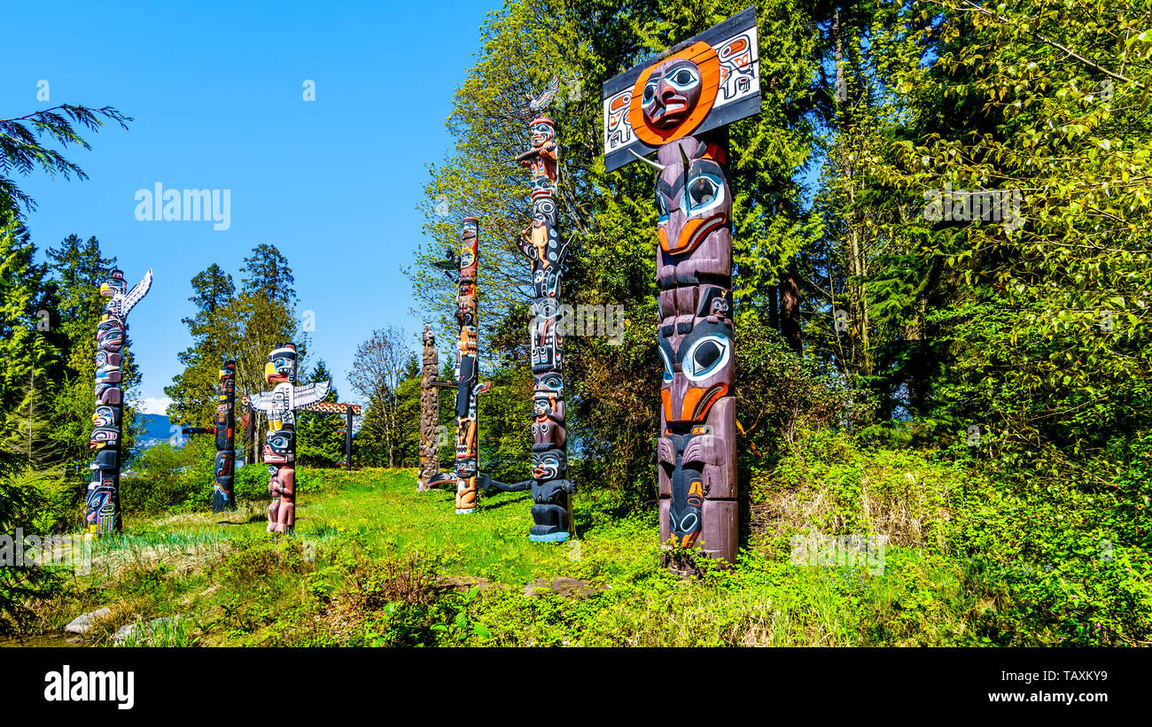 Colorful indigenous Totem Poles representing art and religious symbols of West Coast Indigenous peoples placed in Stanley Park in Vancouver, Canada Stock Photo