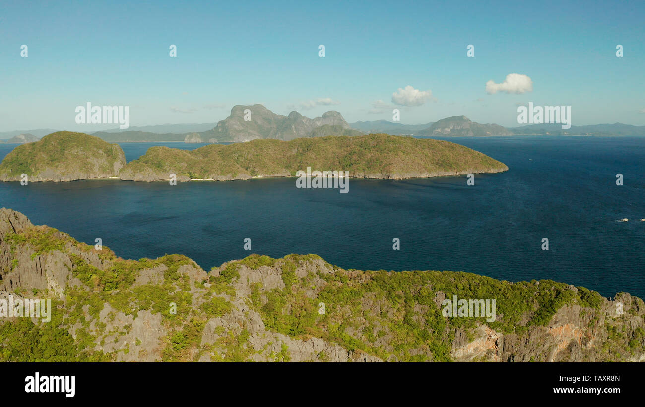 Bay and the tropical islands. Seascape with tropical rocky islands, ocean blue wate, aerial view. islands and mountains covered with tropical forest. El nido, Philippines, Palawan. Tropical Mountain Range Stock Photo
