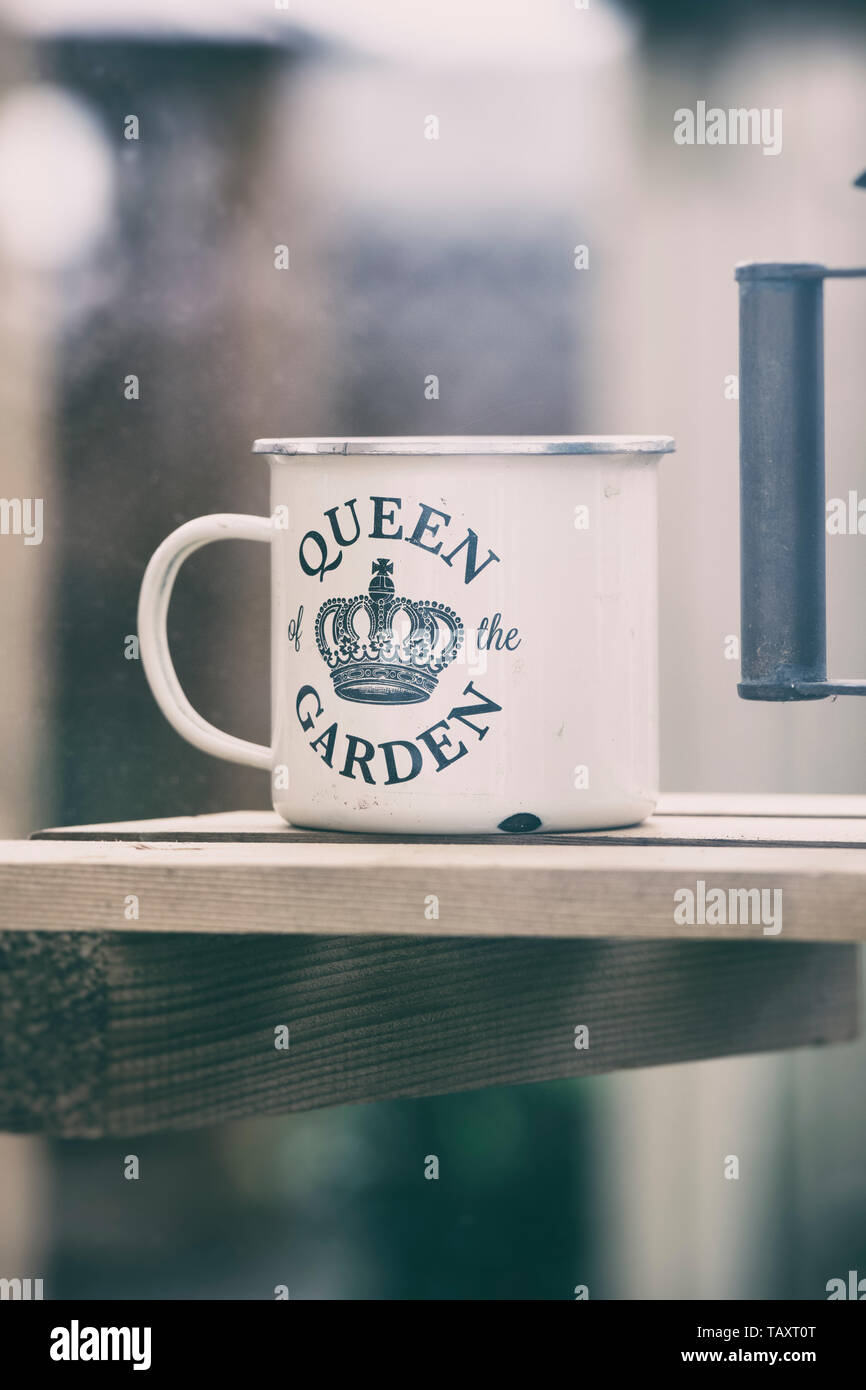 Queen of the garden mug in a greenhouse on a display. UK. Vintage filter applied Stock Photo