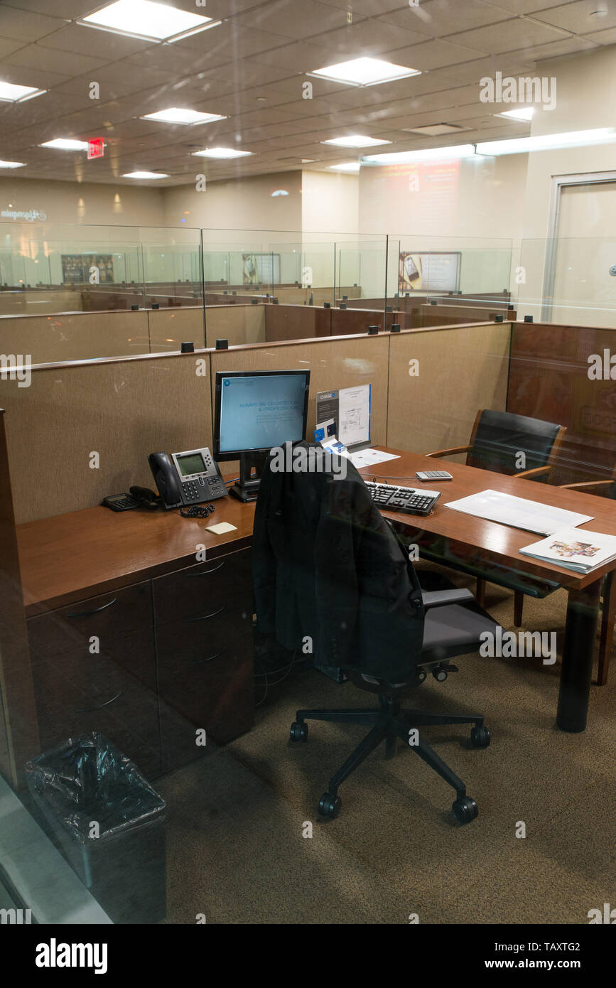 Jacket on the back of a chair in an empty office at night, Manhattan, New York, USA. Stock Photo