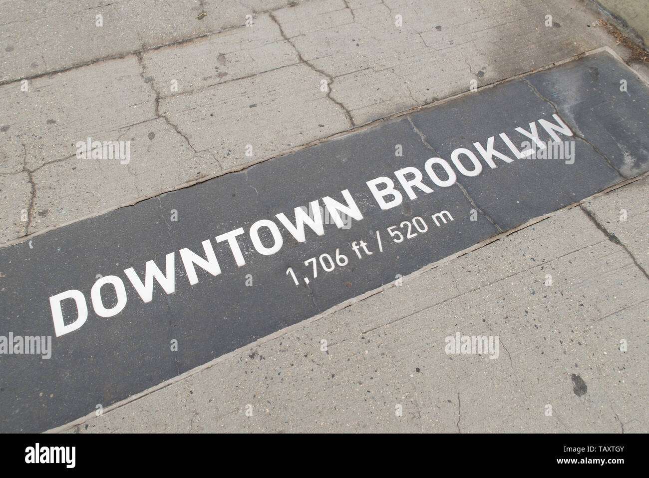 Signs on the ground indicating distances from the end of Brooklyn ...
