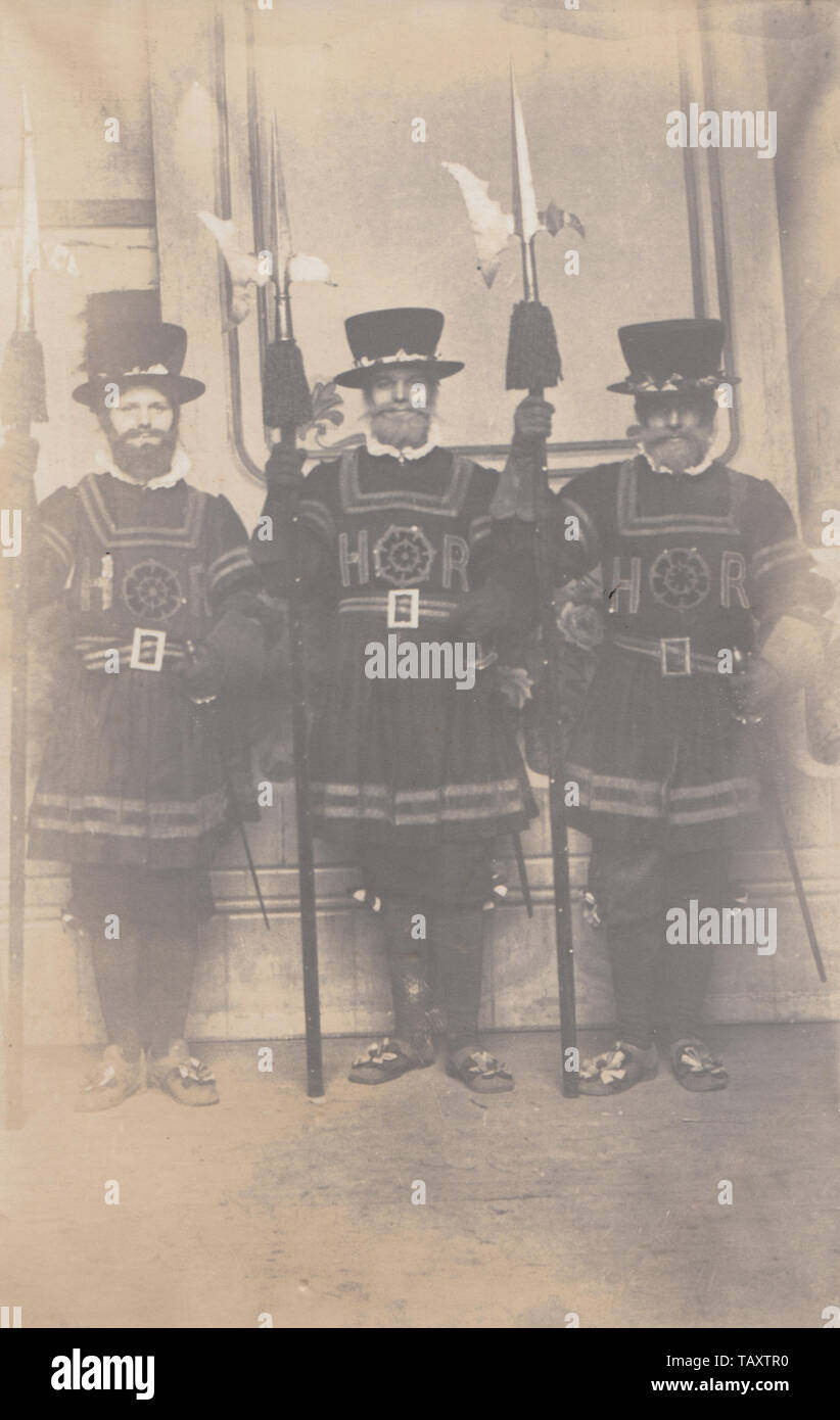 Vintage Photographic Postcard Showing Three People Dressed up as Yeomen Warders (Beefeaters) Stock Photo