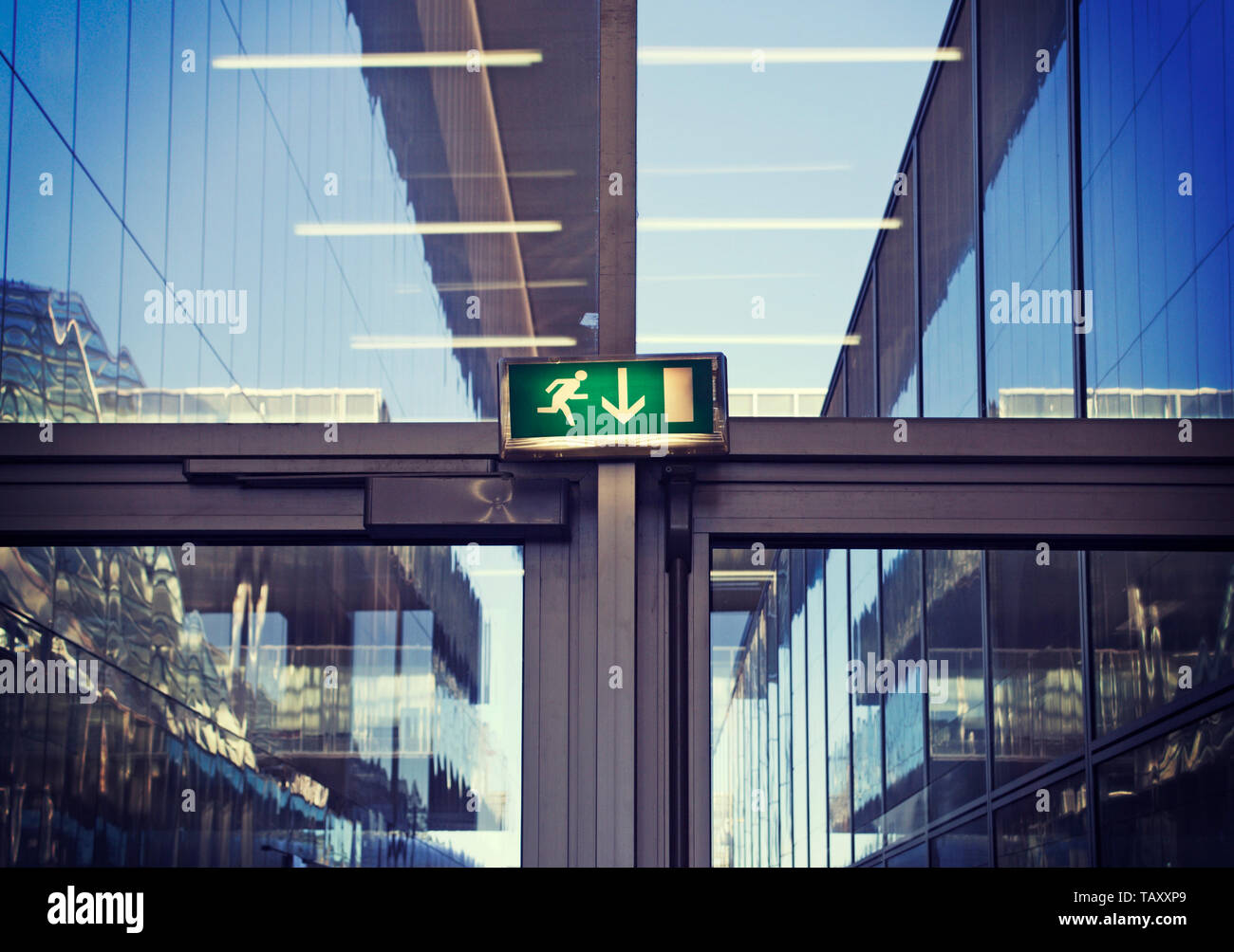 emergency exit sign inside a modern office building Stock Photo