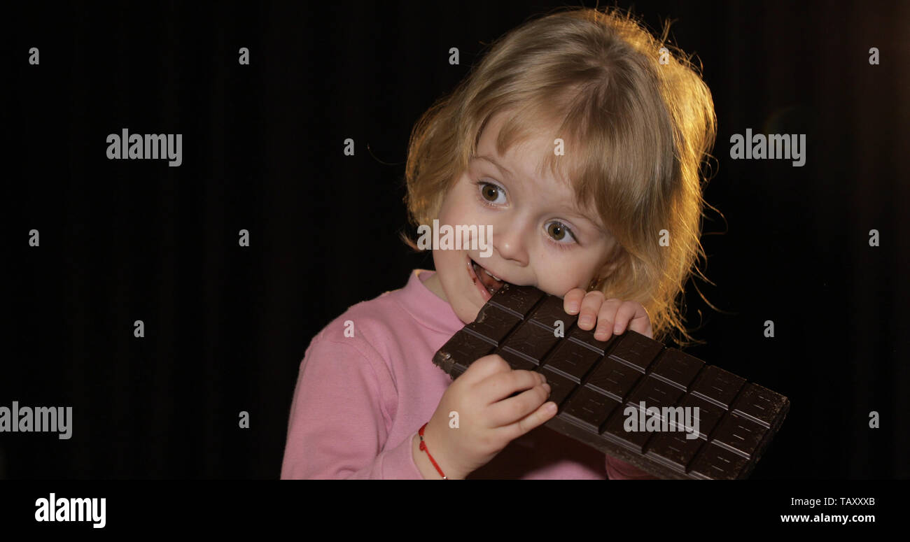 Attractive Child Eating A Huge Block Of Chocolate Cute Blonde