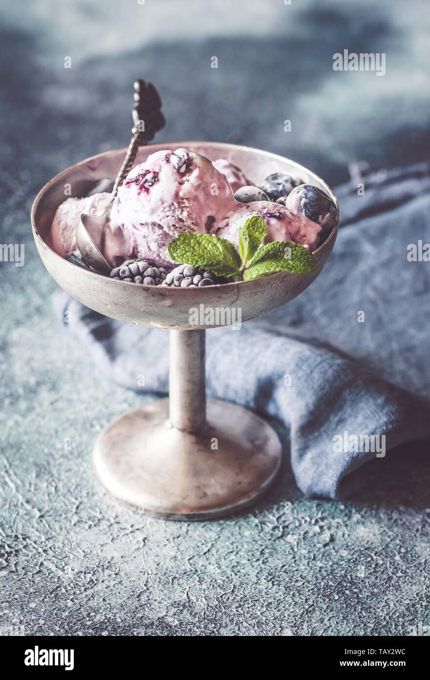 Fruit ice-cream with fresh blueberries and blackberries in vintage vase Stock Photo