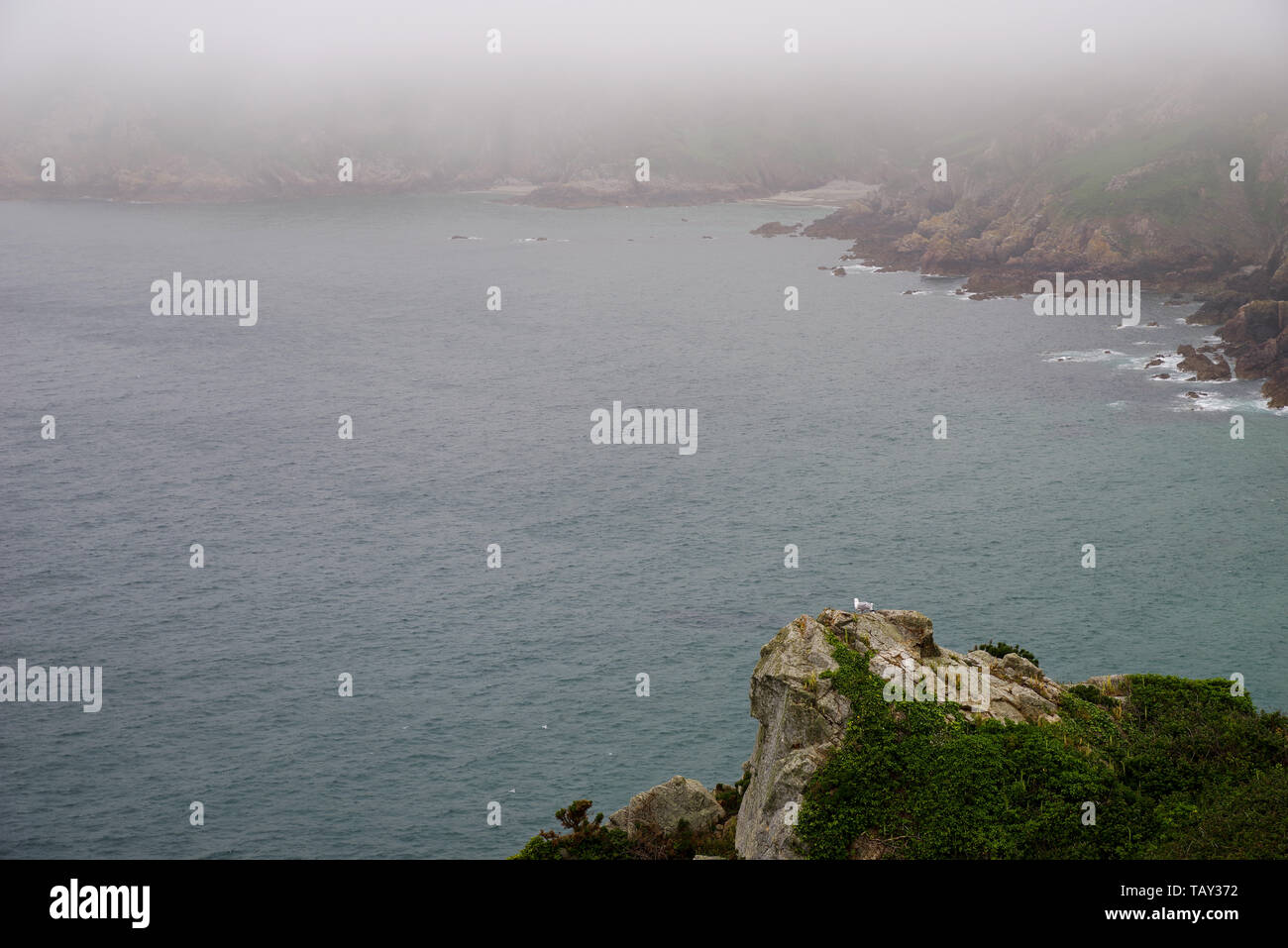 Sea fret rolling in over Icart Bay - Guernsey, Channel Islands (UK) Stock Photo