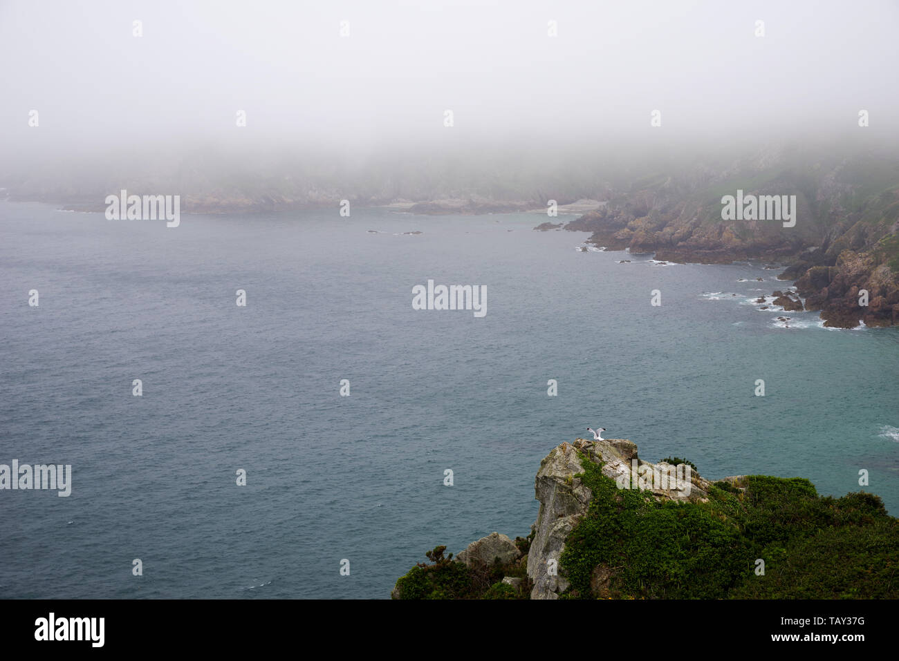 Sea fret rolling in over Icart Bay - Guernsey, Channel Islands (UK) Stock Photo