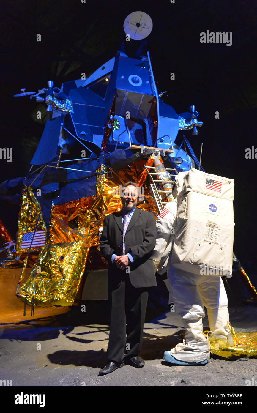 Garden City, New York, USA. May 23, 2019. ANDREW CHAIKIN, best-selling author of A Man on the Moon: The Voyages of the Apollo Astronauts, poses next to the genuine Lunar Module LM-13, built for cancelled Apollo 18 mission and used in HBO miniseries From the Earth to the Moon, which was mainly based on his book. Chaikin talked about growing up on Long Island during the Apollo space program and interviewing Apollo astronauts, at event during the Cradle of Aviation Museum celebration of 50th Anniversary of Apollo 11. Stock Photo