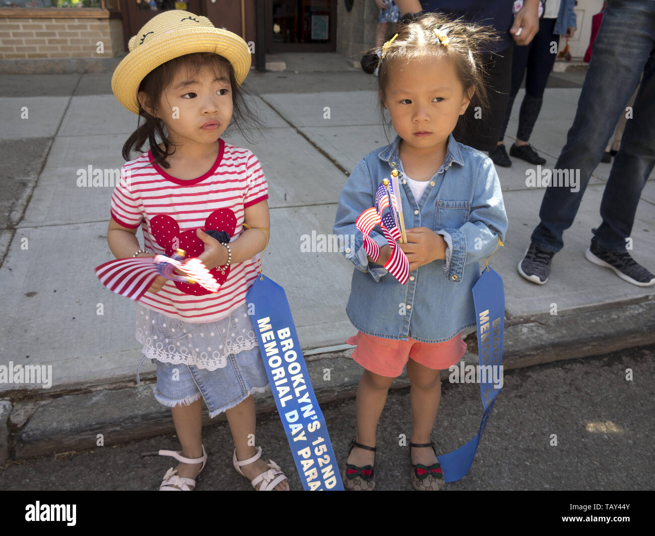 Young, Chinese girls watch The Kings County 152nd Memorial Parade in the Bay Ridge section of Brooklyn, NY, May 27, 20019. Stock Photo