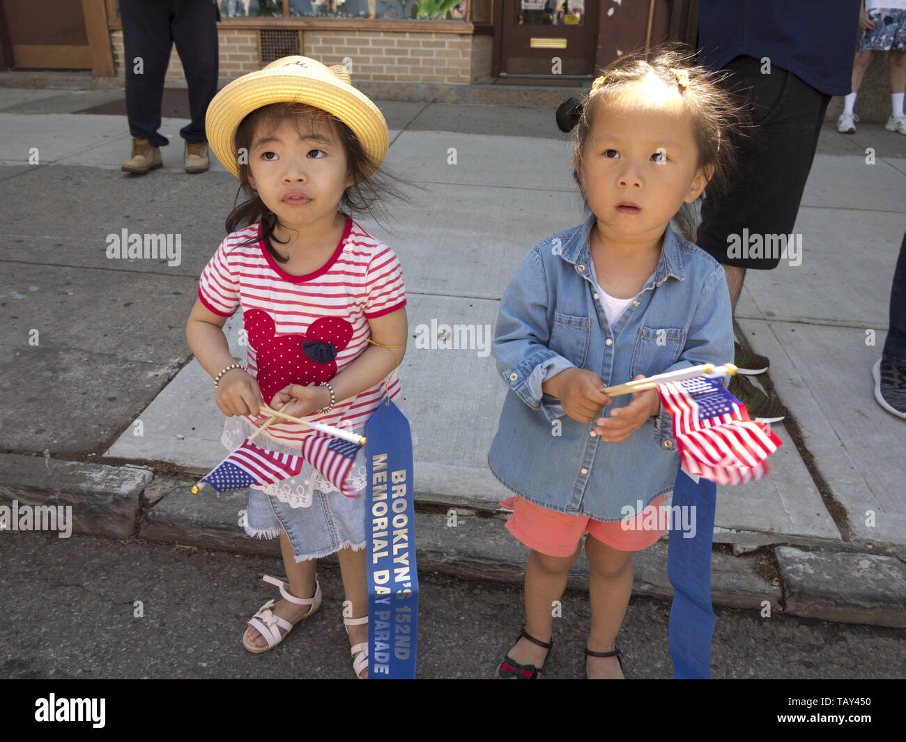 Young, Chinese girls watch The Kings County 152nd Memorial Parade in the Bay Ridge section of Brooklyn, NY, May 27, 20019. Stock Photo