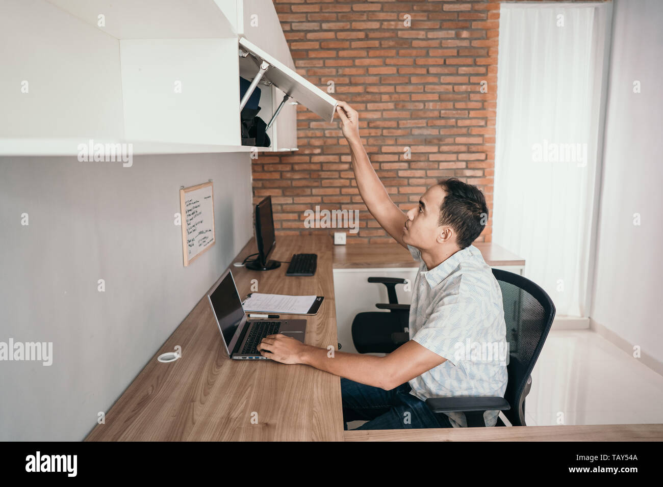 Asian Business Man Work In The Office And Take Files In The Top