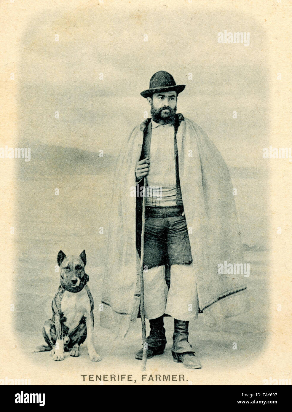 Man from Tenerife with cape and dog (Dogo Canario) ,  (postcard, ca. 1910) Stock Photo