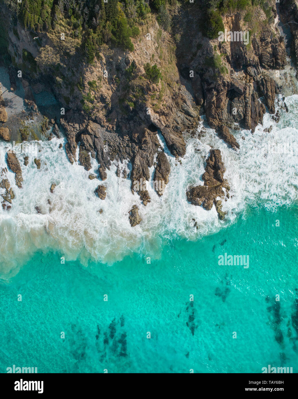 Aerial shot of the ocean and rocky cliffs. Drone nature shot Stock Photo