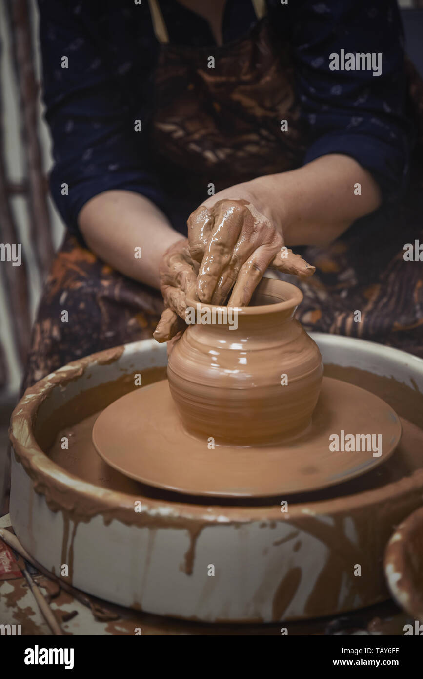 Pottery. The master at the potter's wheel, produces a vessel of clay. Stock Photo