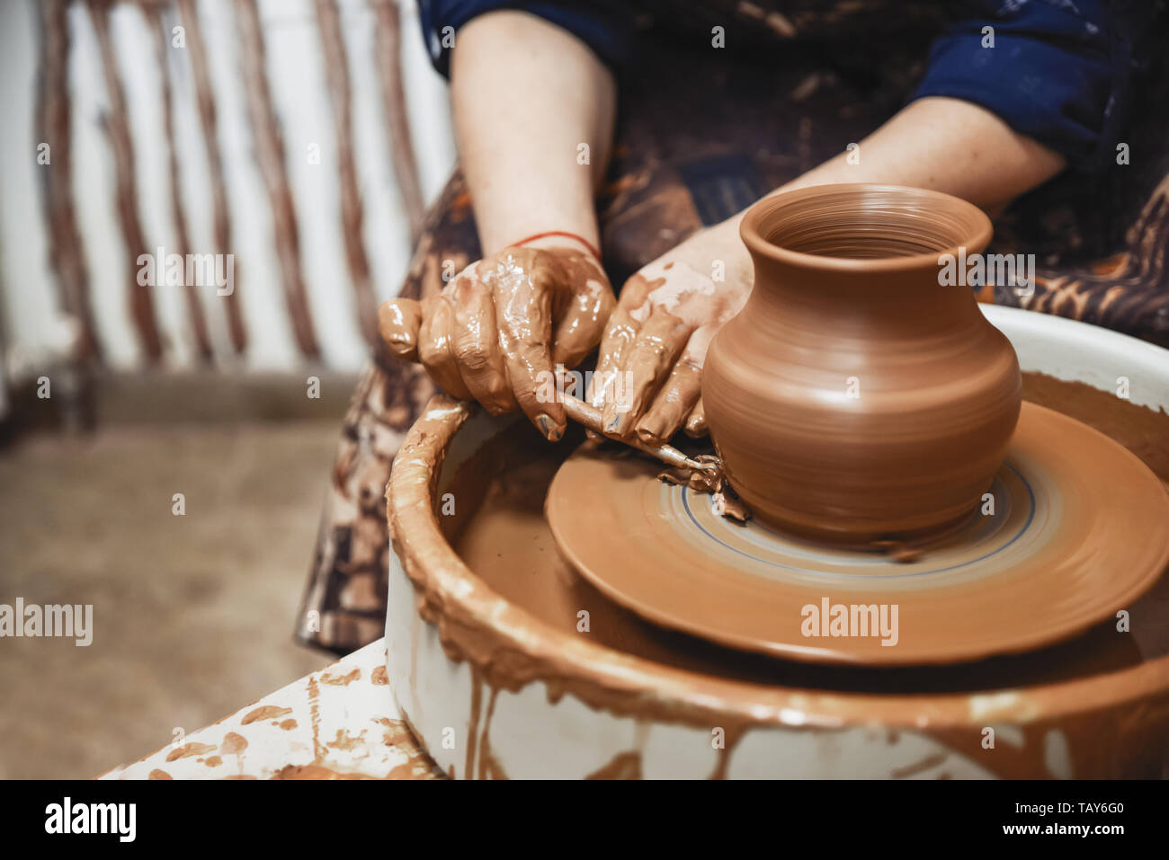 Pottery. The master at the potter's wheel, produces a vessel of clay. Stock Photo