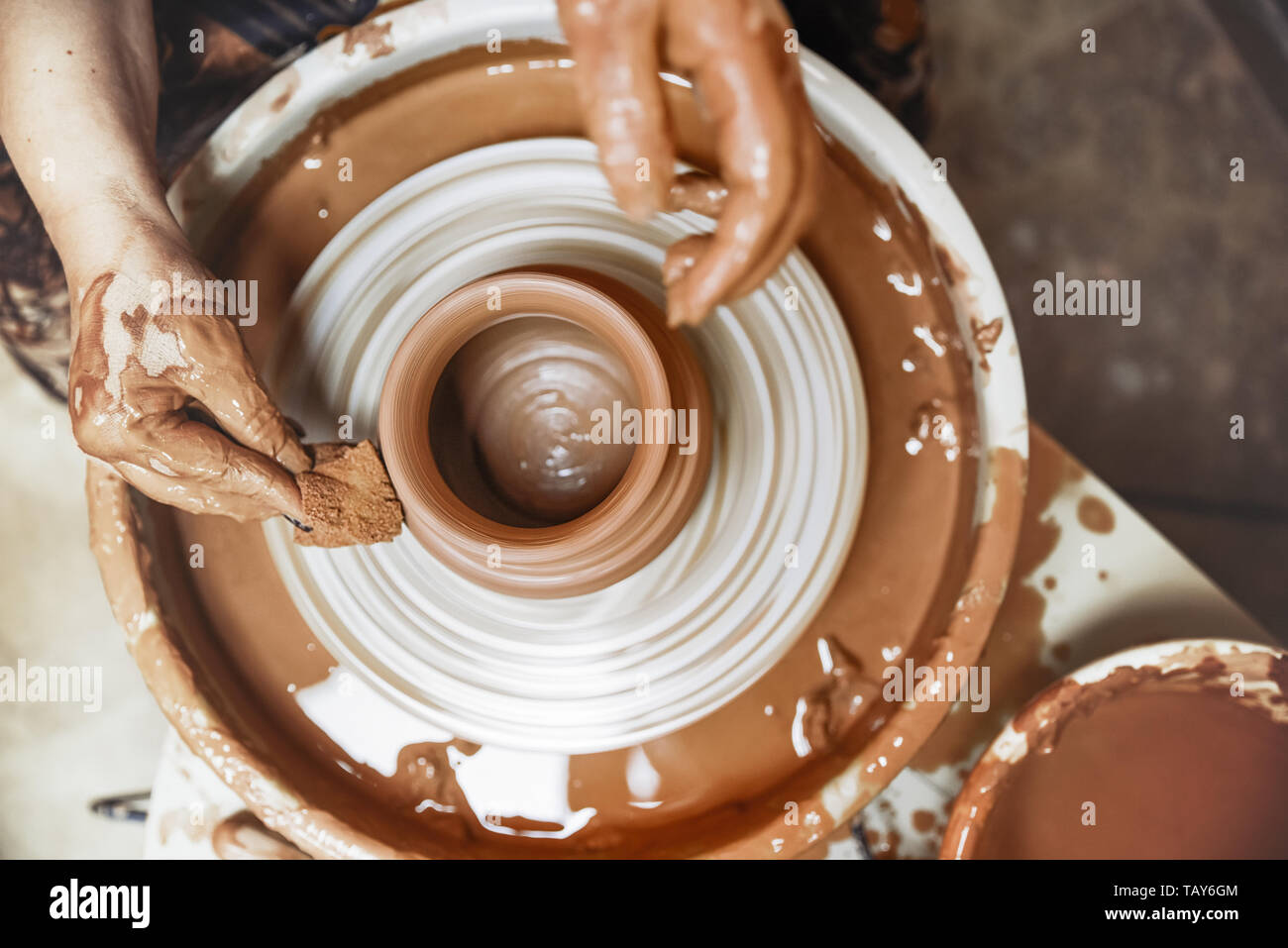 A spinning potter's wheel with a vessel. Close-up Stock Photo