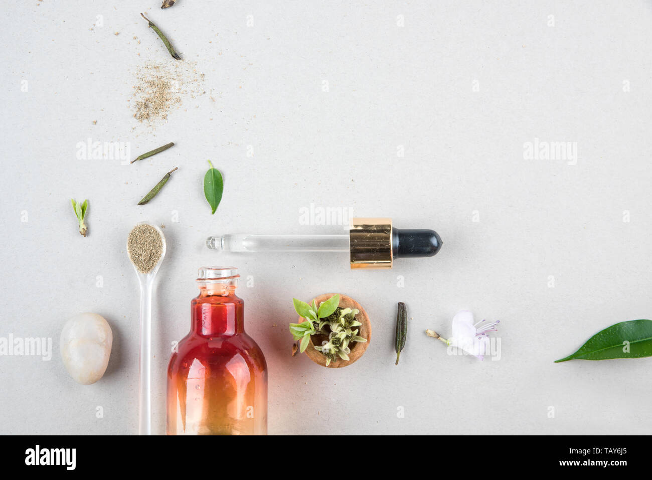 The minimal style. Natural cosmetics, handmade skin and body care. Orange bottle with piped and vegetable ingredients. Flat lay Stock Photo