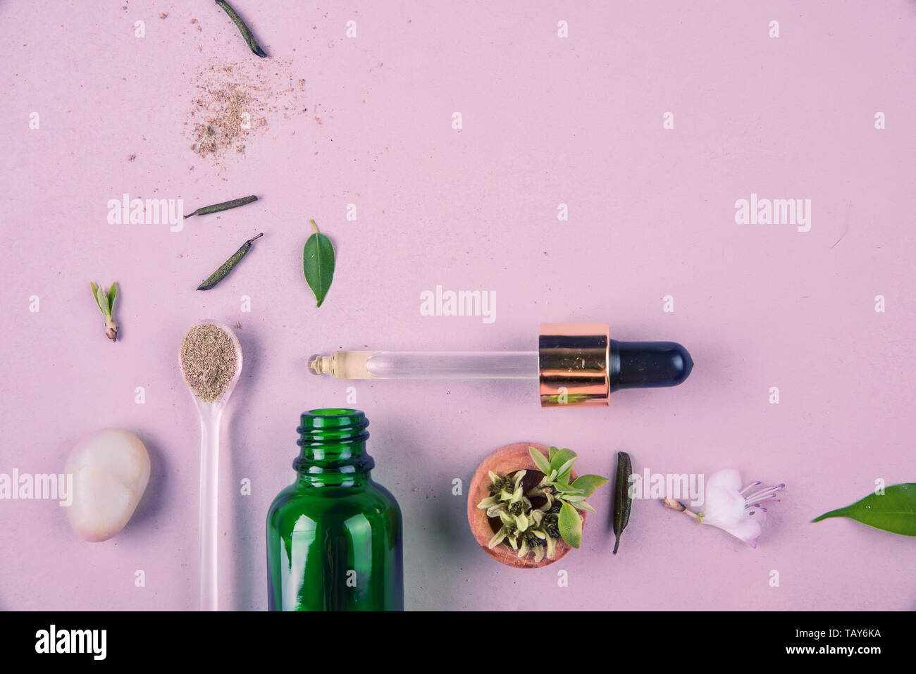 The minimal style. Natural cosmetics, handmade skin and body care. A green bottle with pipets and plants. The concept of orangic cosmetics. Flat lay Stock Photo