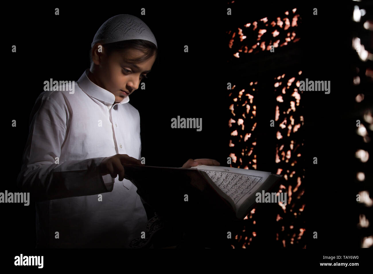 Muslim Young Kid Reading Quran Stock Photos & Muslim Young Kid Reading
