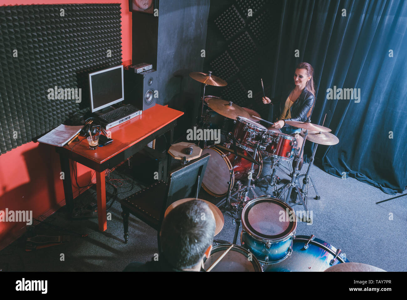 Woman receiving drum lessons from her music teacher Stock Photo