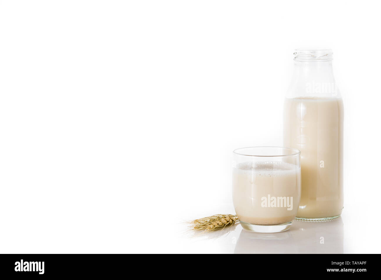 Oats milk in bottle and glass isolated on white background Stock Photo