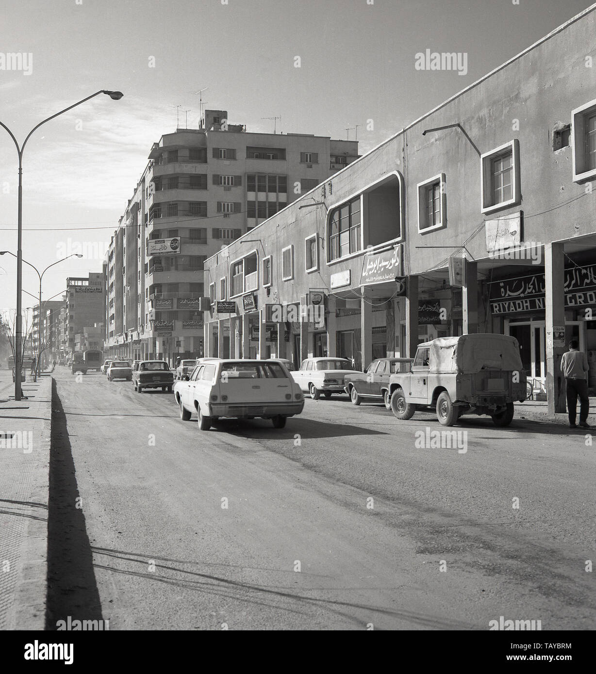 1960s, historical, daytime and a dusty street in Riyadh showing