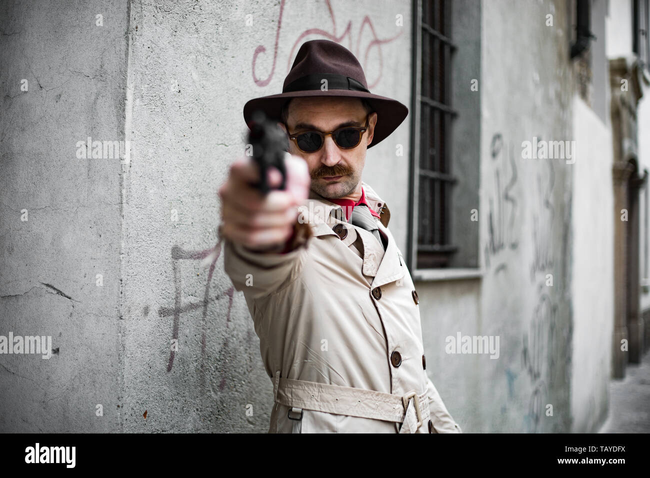 Hitman pointing the gun to the camera, execution concept Stock Photo