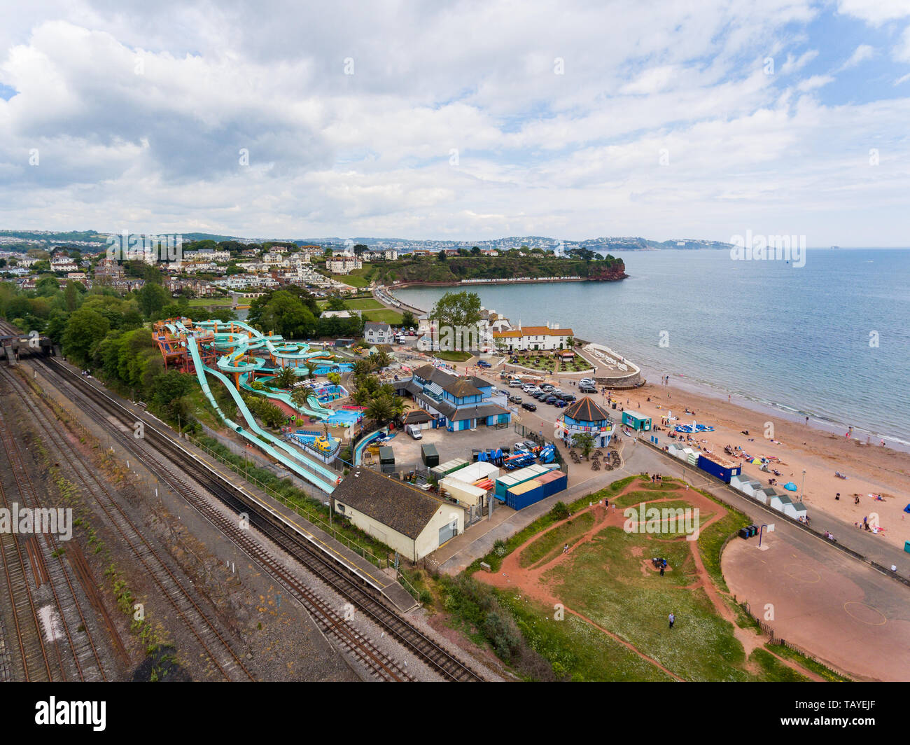 Aerial drone view looking straight down from above colorful summer time fun at water park near a beach Stock Photo