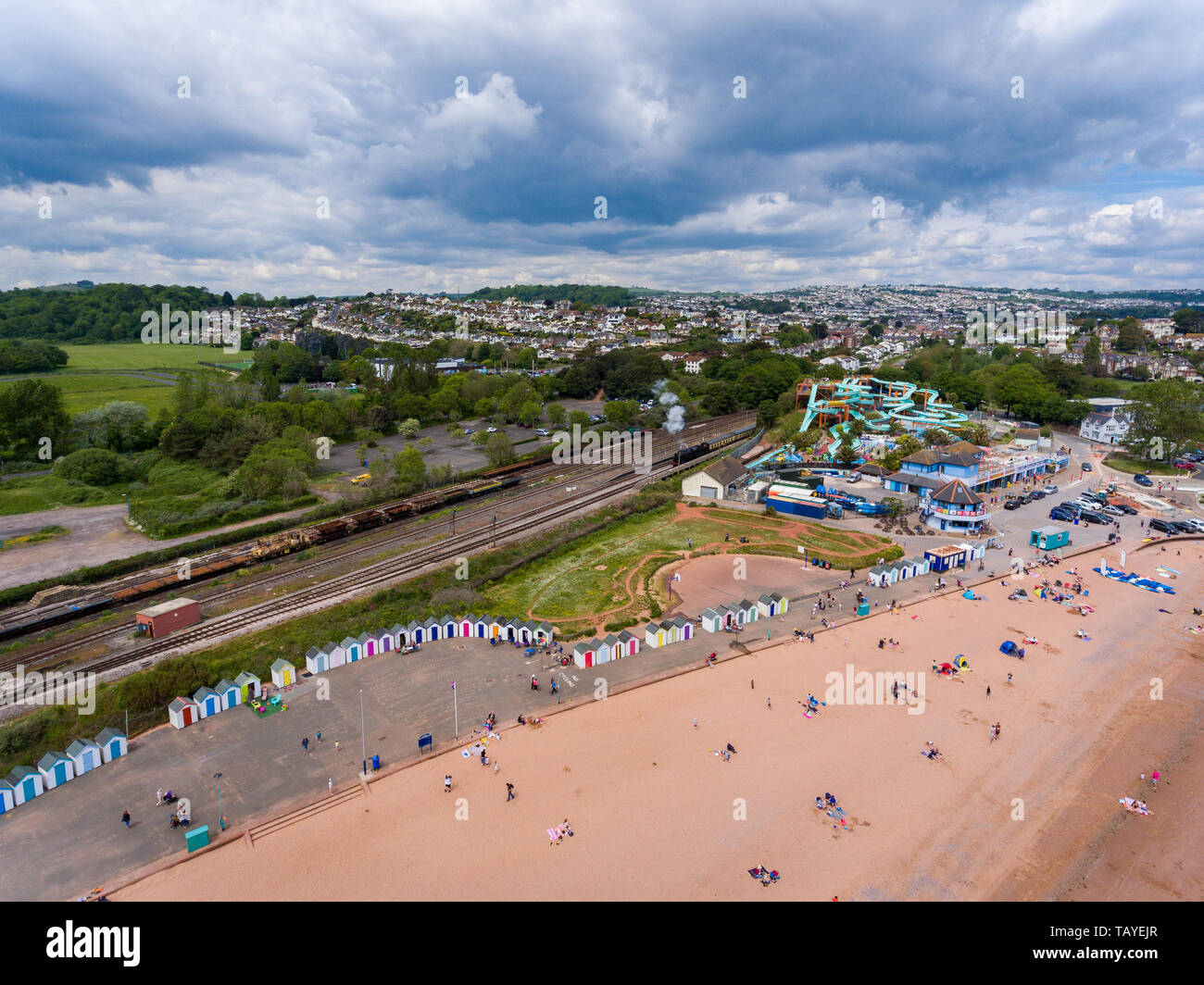 Aerial drone view looking straight down from above colorful summer time fun at water park near a beach Stock Photo