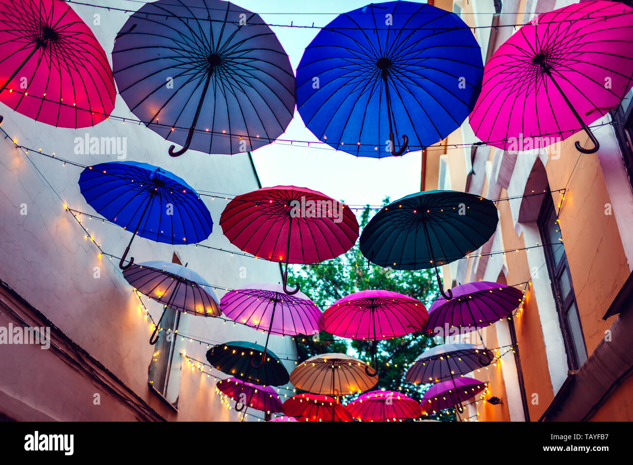 City street decorated with colorful umbrellas and lights. Architecture  exterior design in the evening. Night background Stock Photo - Alamy