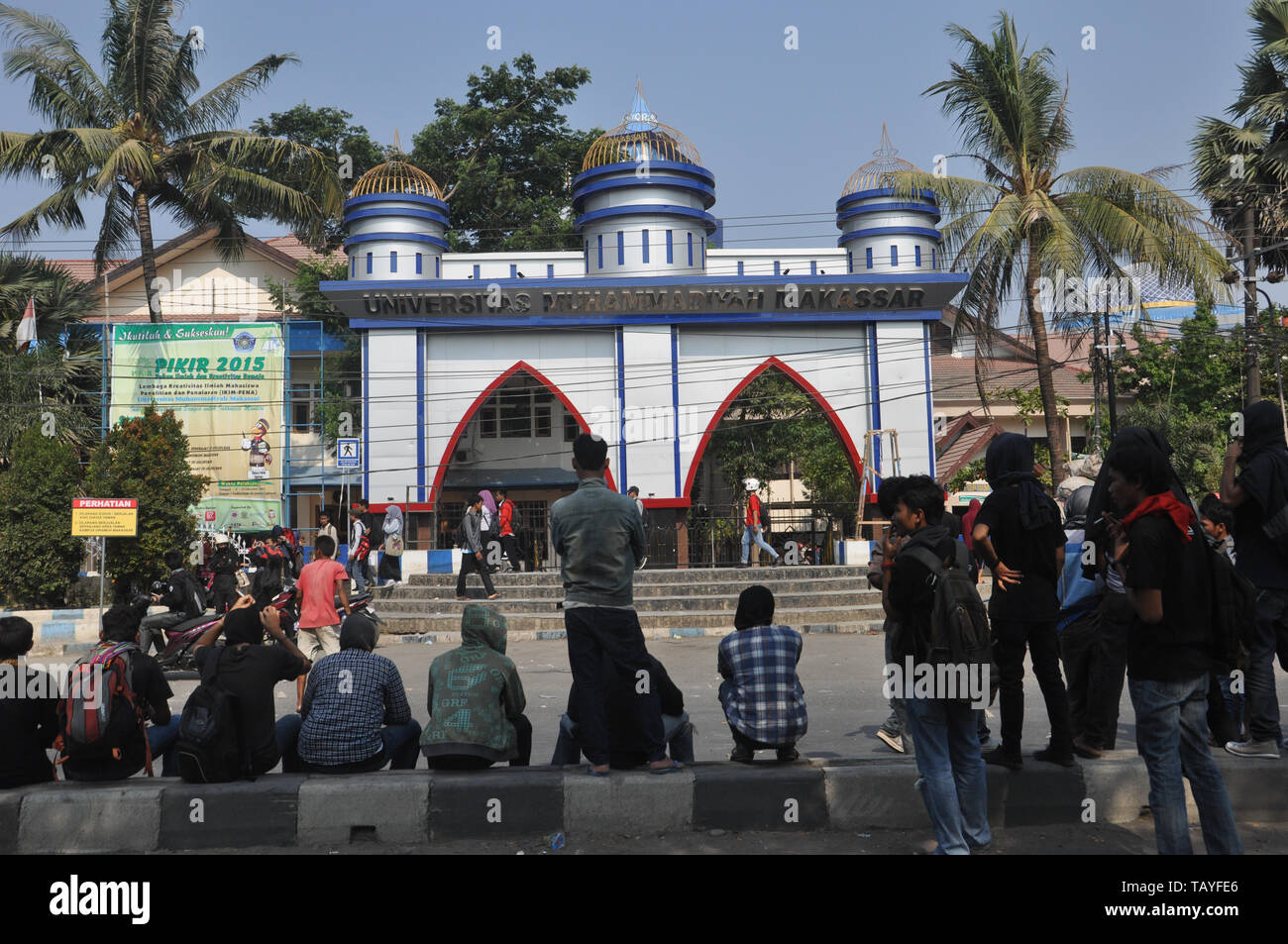 Demonstrant sit in front of Muhammadiah University gate at Allaudin Street during students rally. University students all over Indonesia hold street r Stock Photo