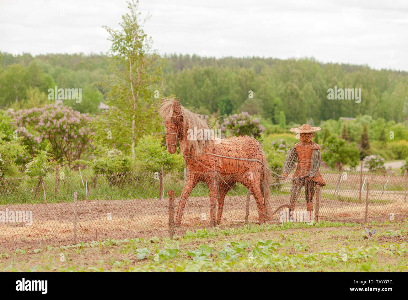 Straw horse, garden sculpture in a farm in Lithuania with straw farmer