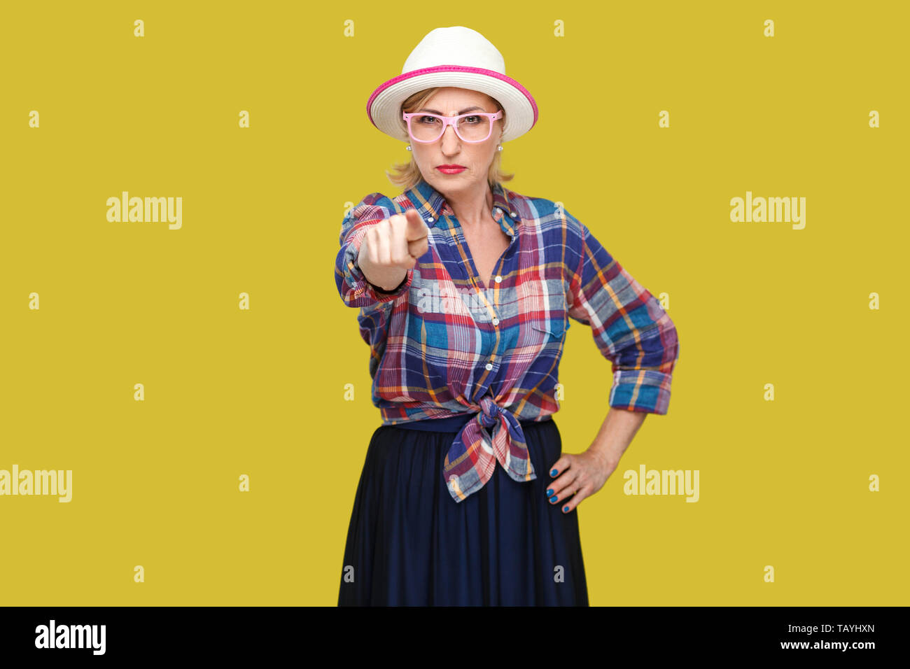 Hey you. Portrait of serious bossy modern stylish mature woman in casual style with hat and eyeglasses standing, pointing and looking at camera. indoo Stock Photo
