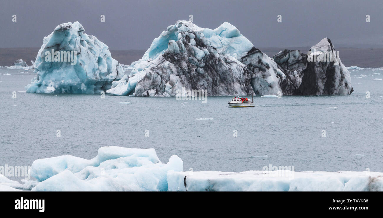 Huge iceberg and resque boat in Iceland Jokulsarlon Stock Photo